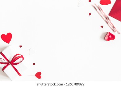 Valentine's Day background. Gifts, candle, confetti, envelope on white background. Valentines day concept. Flat lay, top view, copy space