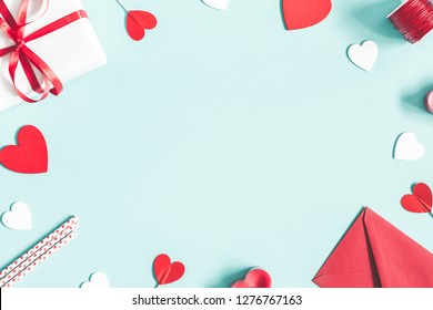 Valentine's Day background. Gifts, candle, confetti, envelope on pastel blue background. Valentines day concept. Flat lay, top view, copy space