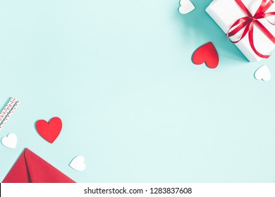 Valentine's Day Background. Gifts, Candle, Confetti, Envelope On Pastel Blue Background. Valentines Day Concept. Flat Lay, Top View, Copy Space