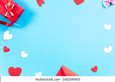 Valentines Day background. Gifts, envelope,white and red hearts on pastel blue background. Valentines day concept.Top view, copy space. - Shutterstock ID 1602590455