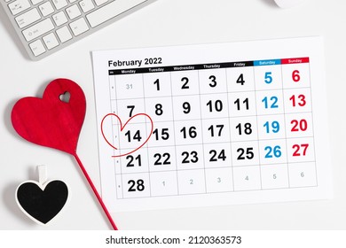 Valentine's Day background. Office table. Date February 14 on calendar 2022, Valentine's Day red heart circled. Flat lay, top view, copy space  - Shutterstock ID 2120363573
