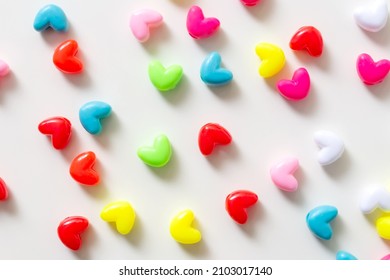 Valentine's Day background. Pink, red, green, blue hearts on a pastel white background. The concept of Valentine's Day. Beads in the form of hearts. Flat layout, top view, copy space - Powered by Shutterstock