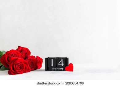 Valentine's day background with red roses bouquet, hearts and calendar with the date 14 february on white background. Greeting card template for Valentines Day. Side view, copy space for text - Powered by Shutterstock