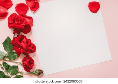 Valentine's day background with red roses and blank card on pink background - Powered by Shutterstock