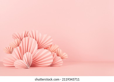 Valentines day background - stage with pink paper ribbed origami hearts on soft light pink color as border with copy space. Love mockup for advertising, design, presentation, card, poster, flyer.