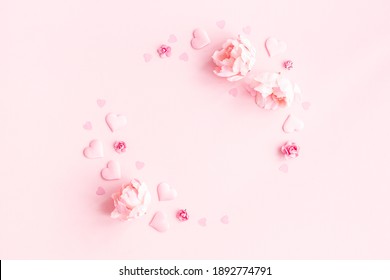 Valentine's Day background. Wreath made of pink flowers, hearts on pastel pink background. Valentines day concept. Flat lay, top view, copy space - Shutterstock ID 1892774791