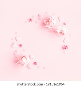 Valentine's Day background. Wreath made of pink flowers, hearts on pastel pink background. Valentines day concept. Flat lay, top view, copy space - Powered by Shutterstock