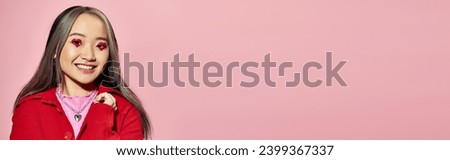 Valentines day banner, jolly asian woman with heart shaped eye makeup posing on pink backdrop