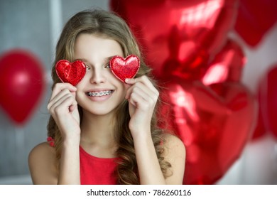 Valentine's Day. Beautiful Girl Red With Heart Balloons. Girl With Braces. Orthodontics Treatment. 