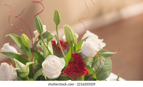 Valentine's Day Bouquet Of Roses And Lilies With Red Sparkly Glitter Sticks. A Pleasant Arrangement Captured In Bokeh. Negative Copy Space For Text Or Additional Design. Celebrating At Home Concept.