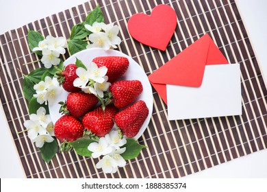 Valentines day card with fresh strawberries and red heart on white background