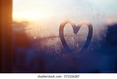 valentines day card, love and kindness concept, heart painted on frozen glass window - Shutterstock ID 571526287