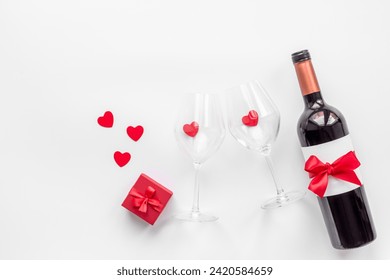 Valentines Day celebration concept. Bottle of wine with two glasses and gift box. - Powered by Shutterstock