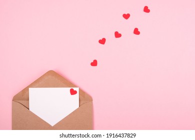 Valentine's day concept. Envelope with a love letter on a pink background.