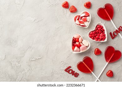 Valentine's Day concept. Top view photo of heart shaped lollipops plates with candies and inscriptions love on concrete texture background with copyspace - Shutterstock ID 2232366671