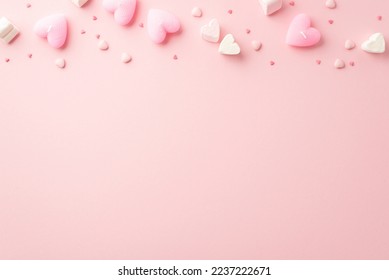 Valentine's Day concept. Top view photo of heart shaped marshmallow candles and sprinkles on isolated light pink background with copyspace - Shutterstock ID 2237222671