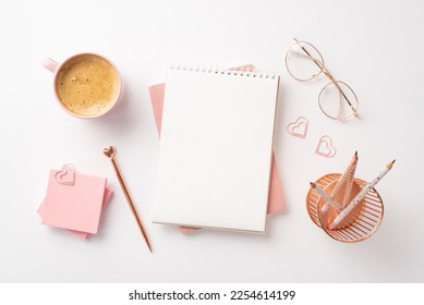 Valentine's Day concept. Top view photo of notepads golden pen glasses pink sticky note paper heart shaped clips pencils holder and cup of coffee on isolated white background with empty space