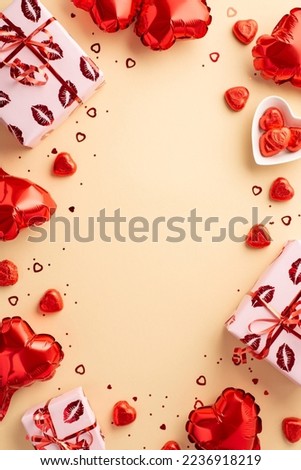 Valentine's Day concept. Top view vertical photo of gift boxes in wrapping with kiss lips pattern heart shaped balloons candies confetti on isolated light beige background with copyspace in the middle
