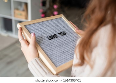 Valentines Day Concept. Young Beautiful Woman Holding Felt Letter Board With The Words Love You