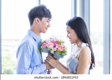 Valentine's Day Concept,asian Young Happy Sweet Couple Holding Bouquet Of Red And Pink Roses After Lunch In A Restaurant Background,Love Story Couple