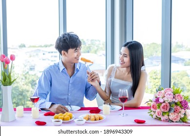 Valentine's Day Concept,Happy Asian Young Sweet Couple Having Romantic The Lunch With A Bouquet Of Roses At The Restaurant Background,Love Story Couple