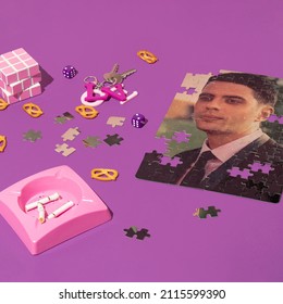 Valentines Day Creative Layout With Love Pendant For Keys, Pink Ashtray With Cigarette Leftovers, And Puzzle Picture Of Man On Bright Purple Background. 80s, 90s Retro Romantic Aesthetic Love Concept.