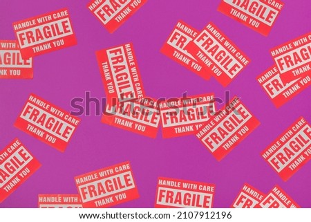 Valentines day creative pattern made with Fragile Warning Sticker Labels on bright purple background. 80s, 90s retro romantic aesthetic love concept. Minimal fashion idea.