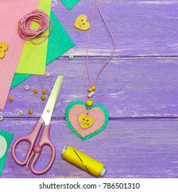 Valentines Day Felt Heart Necklace. Valentine's Day Necklace Made Of Felt, Beads And A Wooden Button. Craft Supplies On A Wooden Background. Gift For Mum. Easy Children Art Creativity Idea