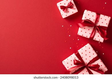 Valentine's Day. Frame of festive gift boxes on red background. View from above. Flat lay. - Powered by Shutterstock