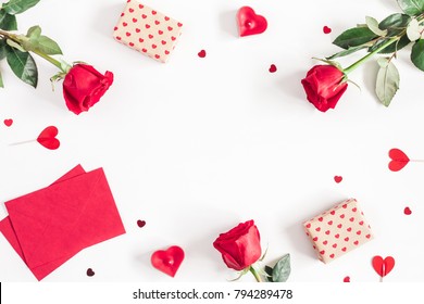 Valentine's Day. Frame Made Of Rose Flowers, Gifts, Candles, Confetti On White Background. Valentines Day Background. Flat Lay, Top View, Copy Space.