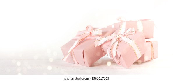 Valentine's Day. Gifts in pink boxes and golden hearts on a light background, festive background, wedding, birthday - Shutterstock ID 1581817183