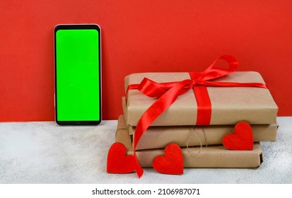 Valentines Day Greeting Card, Festive Gift Box With Red Ribbon And Wooden Decorations Shape Heart, Eco Friendly Craft Package And Zero Waste Holiday, Green Screen Cell Phone Chroma Key.