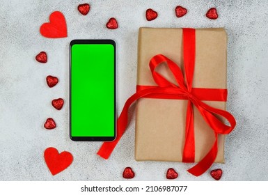 Valentines Day Greeting Card, Festive Gift Box With Red Ribbon And Wooden Decorations Shape Heart, Eco Friendly Craft Package And Zero Waste Holiday, Green Screen Cell Phone Chroma Key.