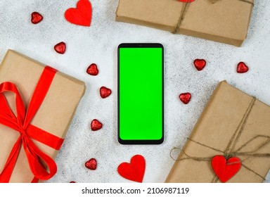 Valentines Day Greeting Card, Festive Gift Box With Red Ribbon And Wooden Decorations Shape Heart, Eco Friendly Craft Package And Zero Waste Holiday, Green Screen Cell Phone Chroma Key.