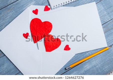 Valentines day greeting card. Handmaded hearts on wooden table.