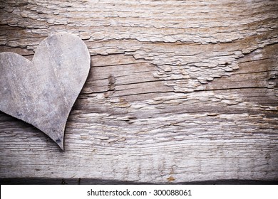 Valentines day greeting card. Heart on the wooden background.