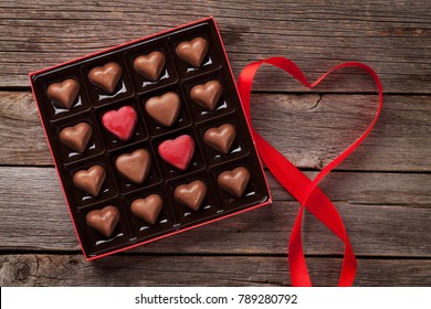 Valentines Day Greeting Card With Heart Chocolate Box On Wooden Table. Top View