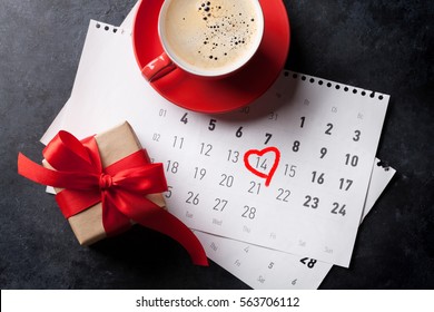 Valentines Day Greeting Card. Red Coffee Cup And Gift Box Over February Calendar. Top View 