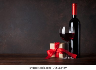 Valentines Day Greeting Card With Red Wine And Gift Box On Wooden Table. With Chalkboard For Your Greetings