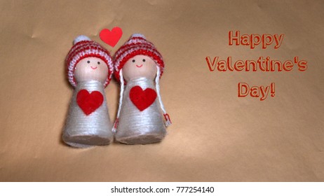 Valentine's day greeting, a couple of wooden toys kisses, a lot of hearts, with record of happy valentine's day