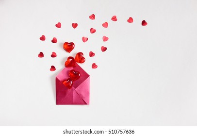 Valentine's Day, Grey Background, Red Envelope With Lots Of Transparent Sweet Hearts And Confetti 