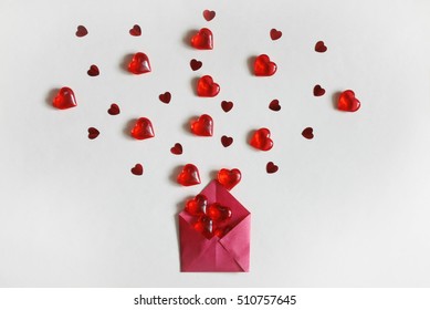 Valentine's Day, Grey Background, Red Envelope With Heap Transparent Hearts And Confetti