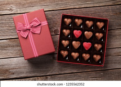 Valentines Day With Heart Chocolate In Box On Wooden Table. Top View