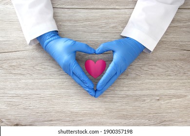 
Valentine's Day. heart in the hands of doctor with latex and female gloves, vintage wooden background for advertising baner - Powered by Shutterstock