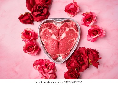 Valentine's Day heart ribeye raw beef steak with roses romantic date night  - Shutterstock ID 1923281246