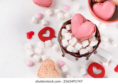 Valentine`s day hot chocolate or coffee latte mug with chocolate drizzle, heart shaped marshmallow and macaron cookie. Sweet treats drink recipe idea, sweet dessert beverage for your Valentine - Powered by Shutterstock