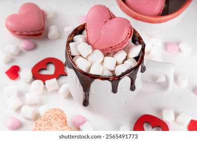 Valentine`s day hot chocolate or coffee latte mug with chocolate drizzle, heart shaped marshmallow and macaron cookie. Sweet treats drink recipe idea, sweet dessert beverage for your Valentine - Powered by Shutterstock