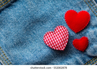 Valentine's Day. jeans background with red heart.