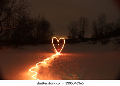 valentines day light painting of heart on frozen lake  - Powered by Shutterstock