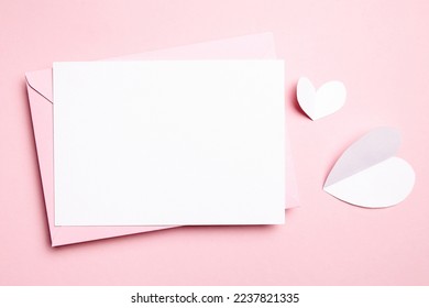 Valentines Day love letter or card mockup with white paper heart on light pink background, top view, flat lay. Blank wedding invitation, empty holiday greeting card mockup - Shutterstock ID 2237821335